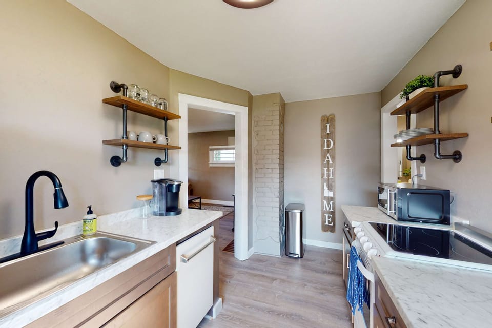 Galley kitchen with black pipe open shelving, and Keurig — everything you need for a quick breakfast before hitting the water