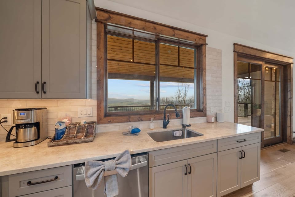 Wash dishes while soaking in sweeping Blue Ridge views. Light-filled and well-equipped for the whole crew.