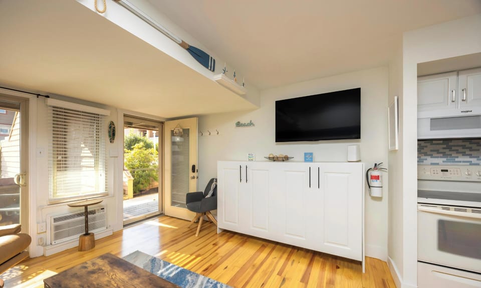 Living room with 2 Murphy beds and sofa bed.