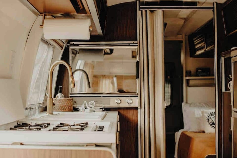 Full kitchen with 4 burner stovetop, gas oven, and bigger-than-mini fridge and freezer