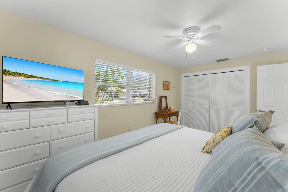 Spacious primary bedroom with a King-sized bed and Roku smart TV