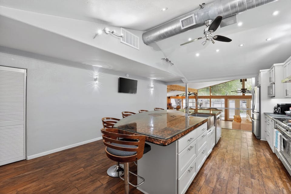 Kitchen island with seating, paired with a fully equipped kitchen.