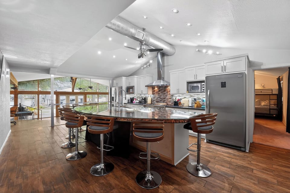 Fully equipped kitchen with island seating, perfect for cooking & dinning.