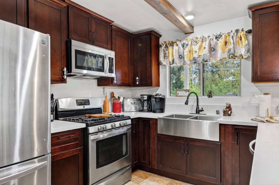 Fully equipped kitchen with spacious island and bar seating.