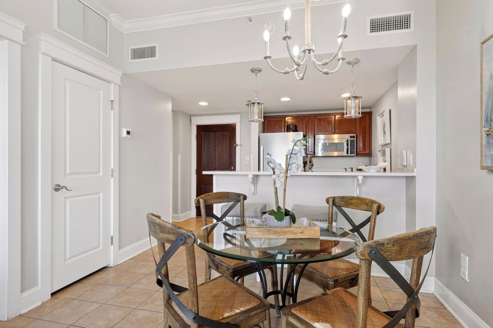 View from the dining area toward the chef’s kitchen, showcasing the breakfast bar and open layout.