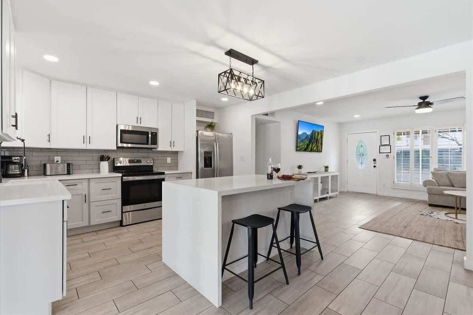 Fully equipped kitchen with stainless steal appliances and a kitchen island with bar seating for 2 guests.