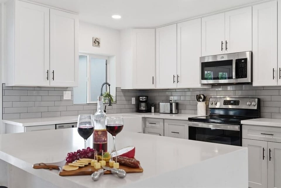 Fully equipped kitchen with stainless steal appliances and a kitchen island with bar seating for 2 guests.