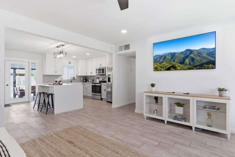 Bright and open living area featuring cozy furnishings and a Smart TV.