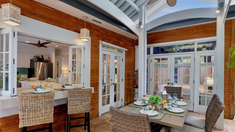 Gather around the dining table where warm wood tones and natural light create a welcoming space for your memorable meals together, perfectly blending indoor comfort with outdoor views.
