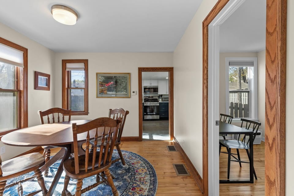 Dining area with views directly into the renovated kitchen and the bright sunroom beyond — a well-connected, light-filled space for every meal.