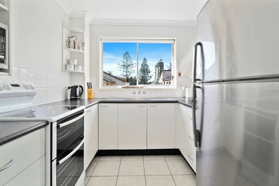 Prepare everything from a quick breakfast to a home-style dinner in the full kitchen, where generous bench space and contemporary appliances make mealtimes effortless.