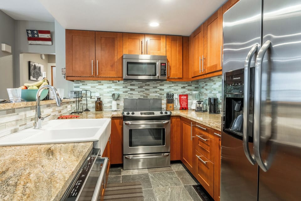 Your gourmet kitchen features granite counters, stainless appliances, and warm wood cabinets—perfect for creating memorable meals during your stay.