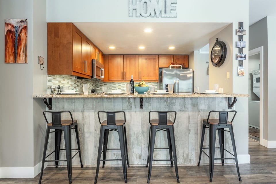 Gather around your stylish kitchen island for morning coffee or evening conversations, featuring modern appliances and comfortable seating.