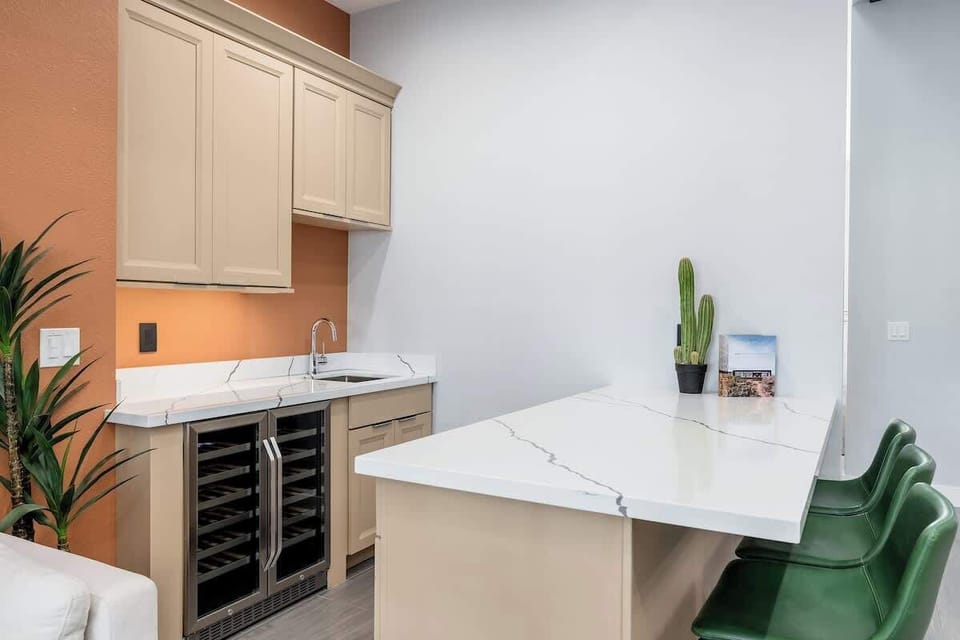 Your stylish kitchenette features sleek marble countertops, modern cabinetry, and a wine cooler—perfect for preparing light meals or enjoying refreshments in comfort.