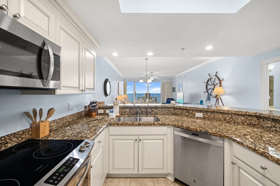 Fully equipped kitchen with bar seating—perfect for cooking and entertaining during your beach getaway.