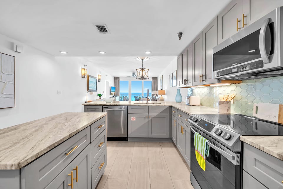 Your culinary dreams come alive in this stunning kitchen featuring marble countertops, premium appliances, and elegant gold accents.