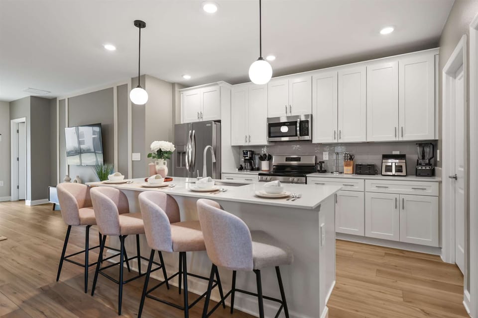 Modern kitchen with center island and 4 high chairs, ideal for casual dining and group meals