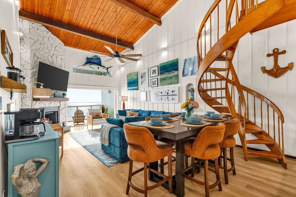 Open kitchen and dining, the staircase at the center.
