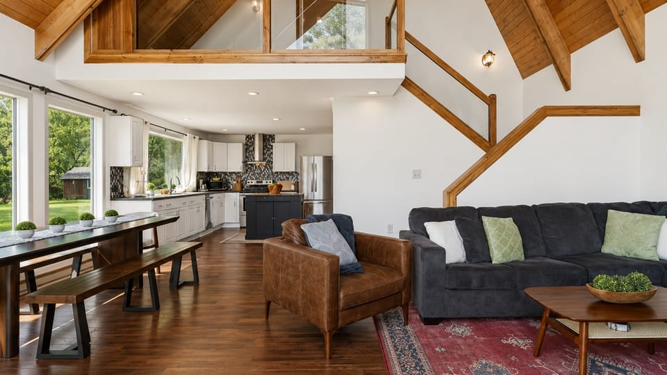 Living and dining areas beneath vaulted ceilings