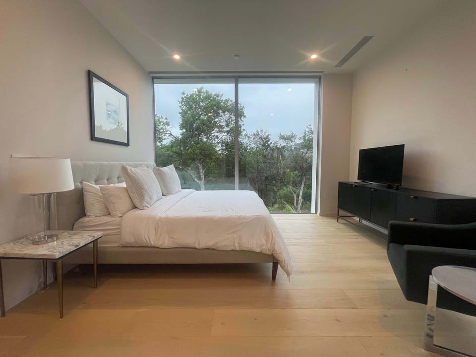 Unwind with treetop views right from your bed — this room was designed for deep rest.