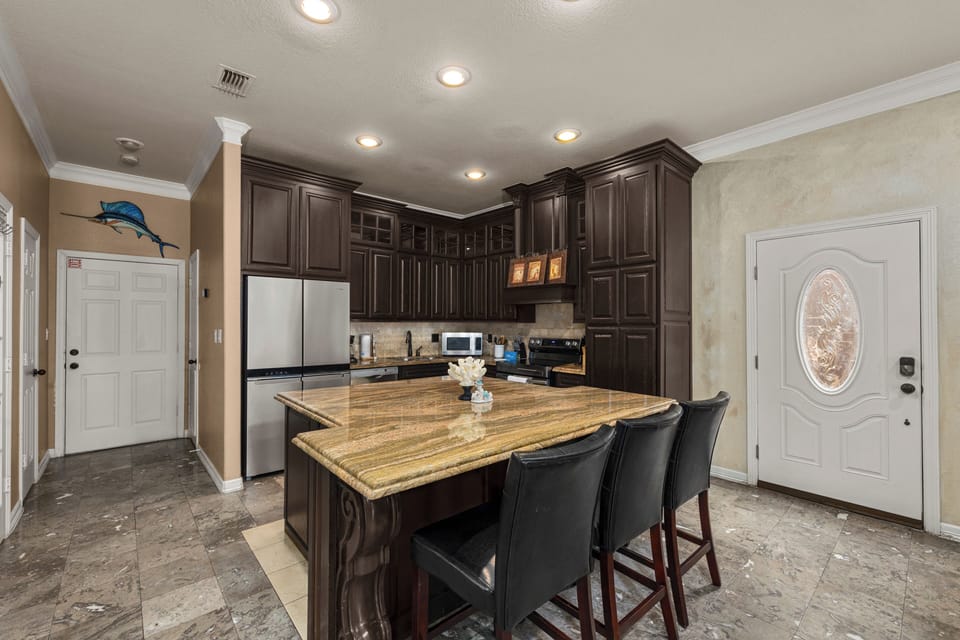 Cook, entertain, and make memories in this beautifully designed kitchen with ample space for everyone to gather.