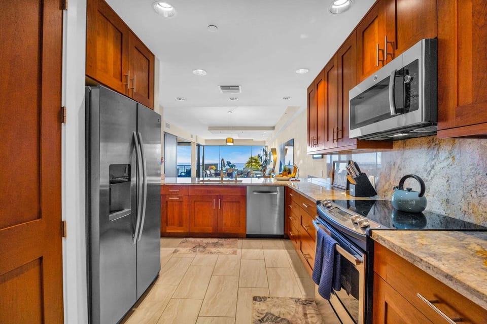A bright kitchen setup that keeps everything within reach while maintaining open sightlines to the living space.