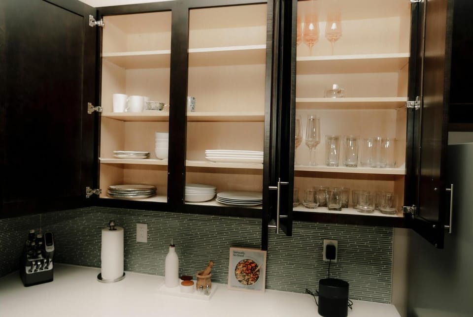 Well-stocked modern kitchen with organized dishes and glassware