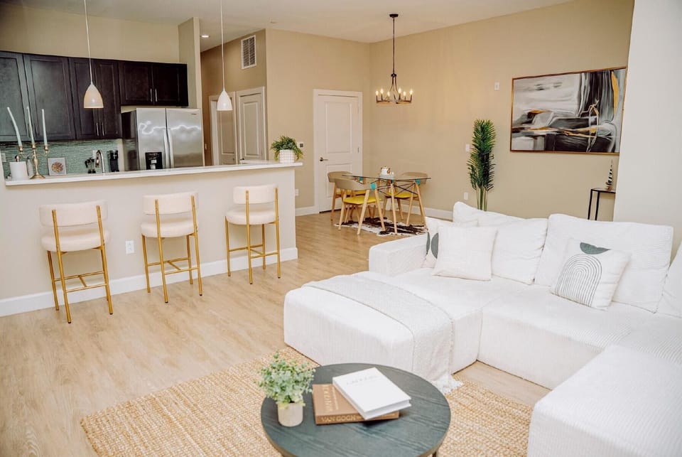 Bright open-concept living space with modern kitchen and cozy sectional