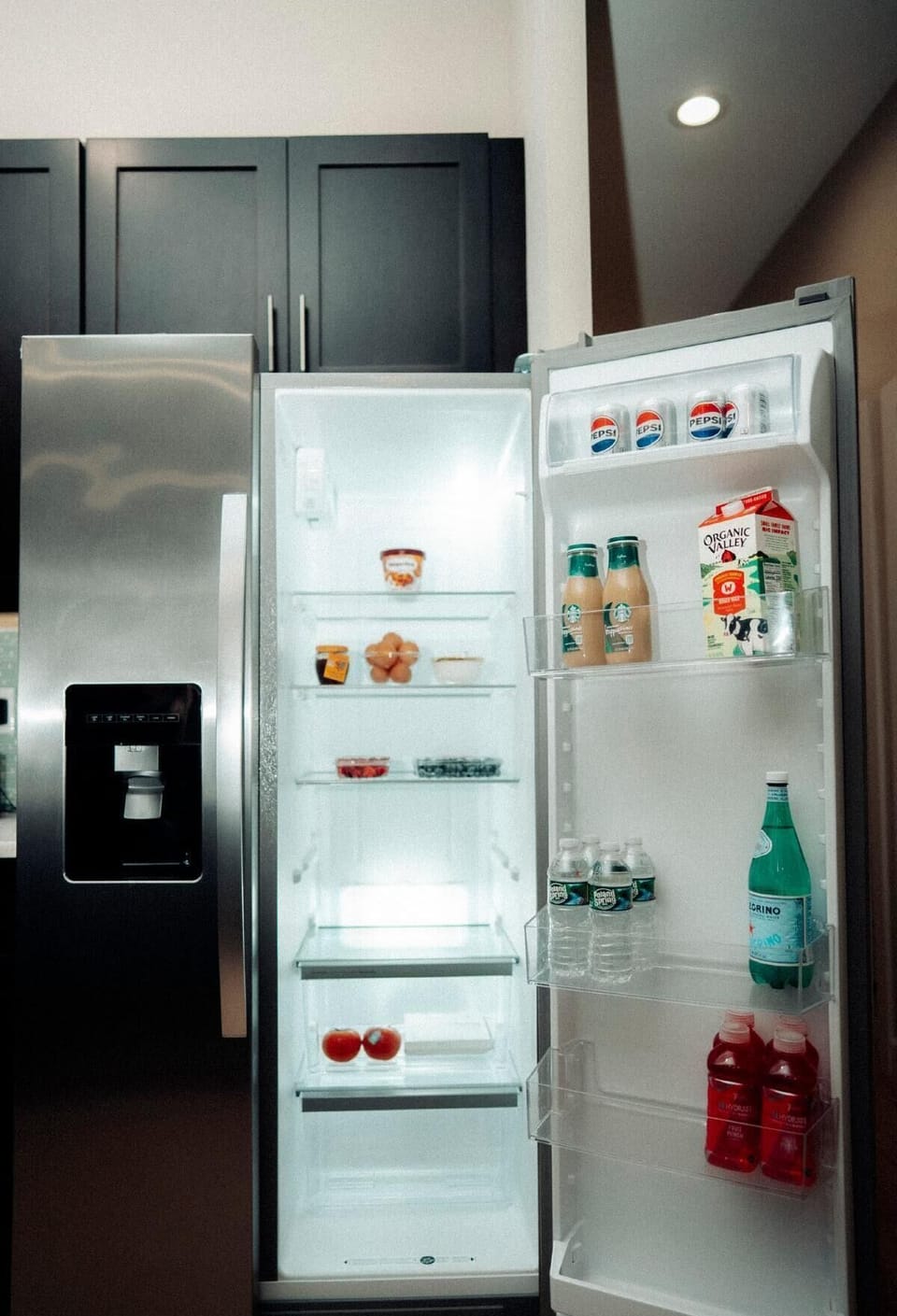Modern kitchen with stocked fridge and thoughtful welcome refreshments