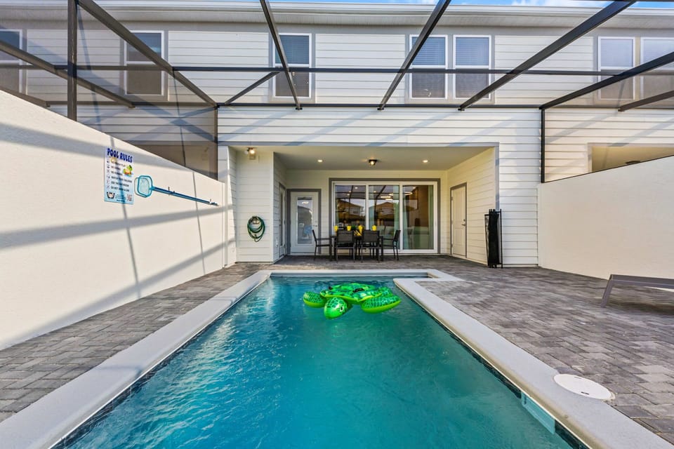 Seamless indoor-outdoor living: the covered patio with dining is just steps from the sparkling private pool-perfect for family fun!