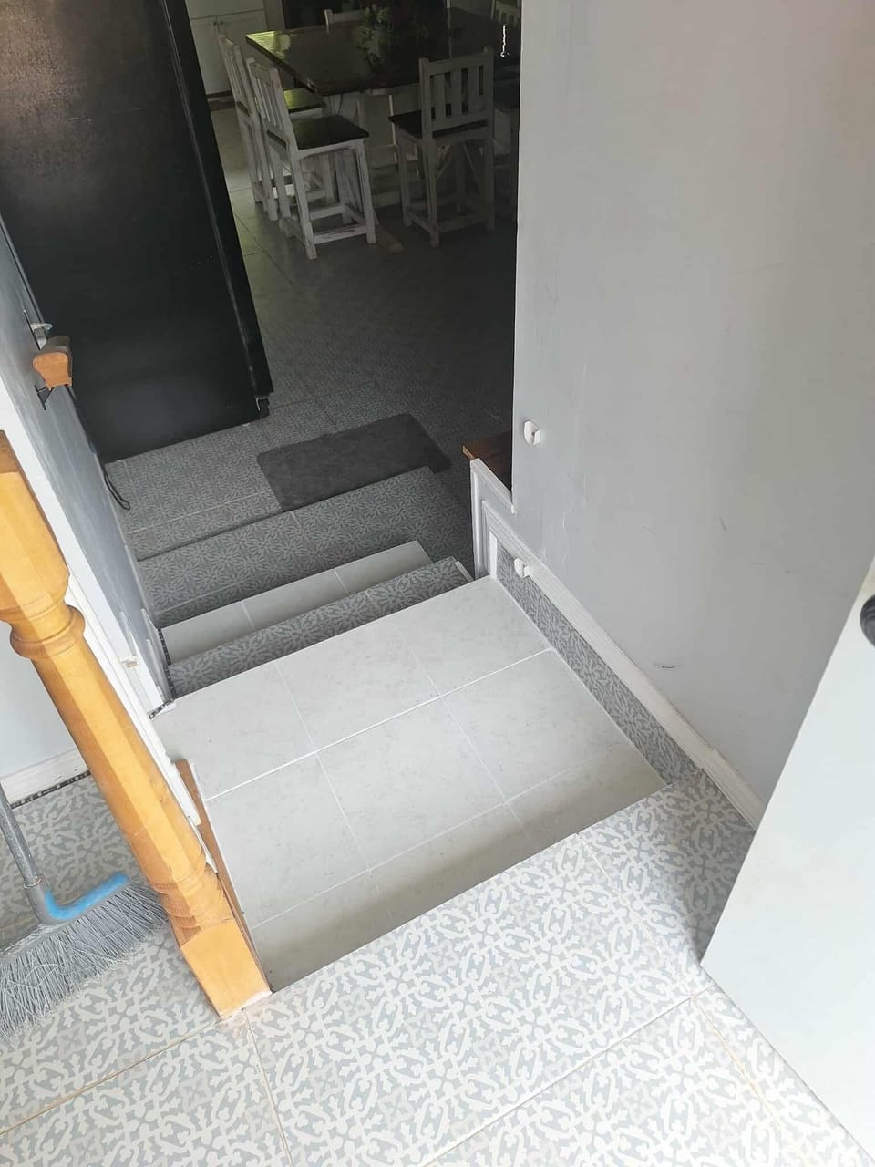 about 4 steps with a handrail into sunken kitchen and dining room. tiles on steps are slip free.