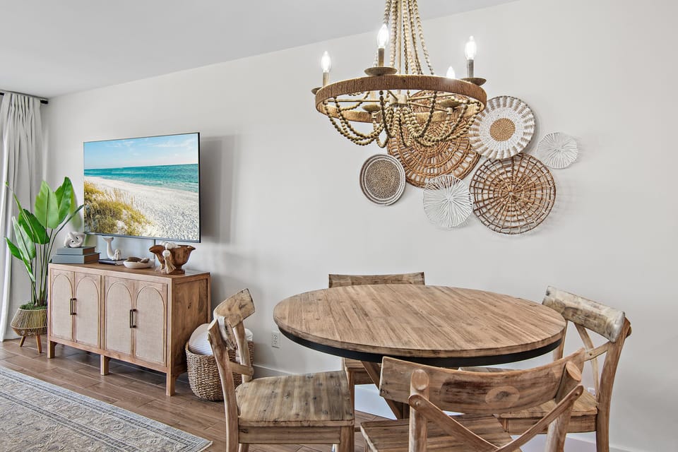 Share meals at the round table beneath a statement light.