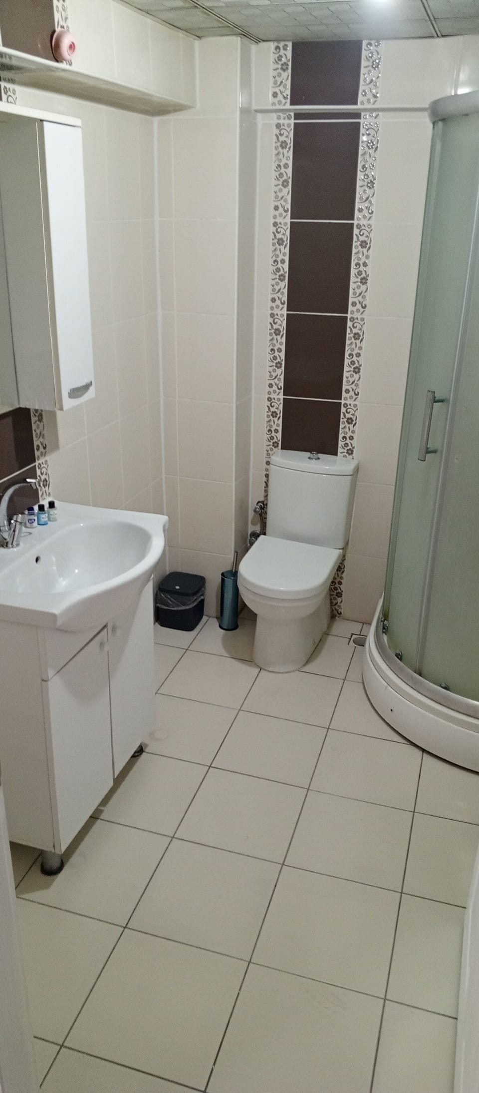 Shower, hair dryer, slippers, towels