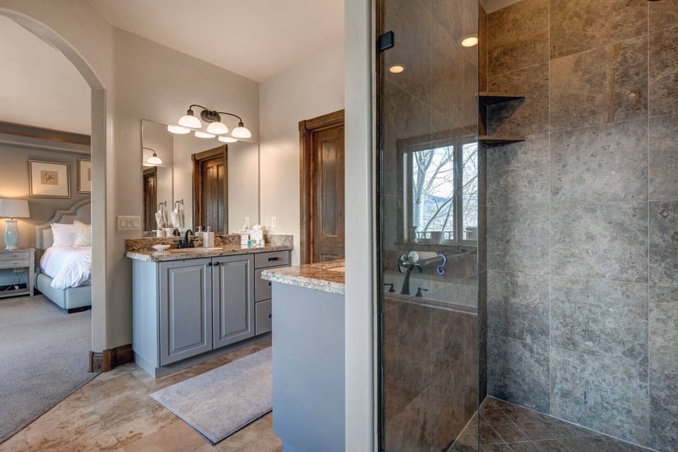Unwind in your private ensuite with a spacious walk-in shower, dual vanity, and warm natural light—your own serene retreat after a day of adventure.