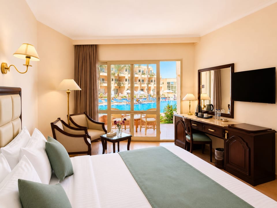 Classic Room, Pool View | Free minibar, in-room safe, iron/ironing board, bed sheets