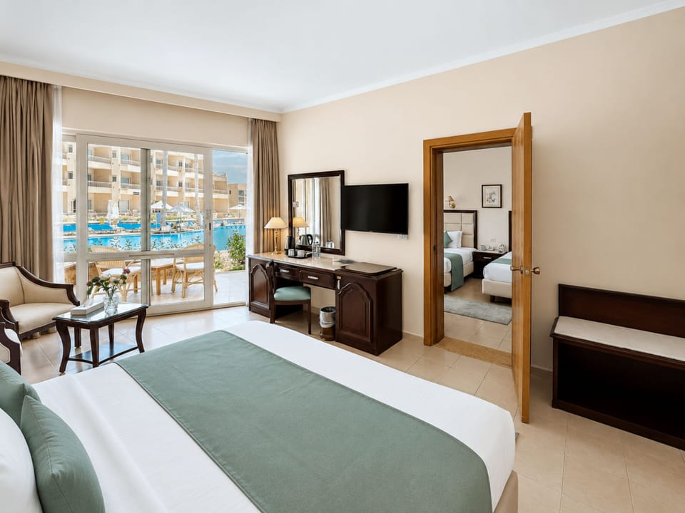 Family Room | Free minibar, in-room safe, iron/ironing board, bed sheets