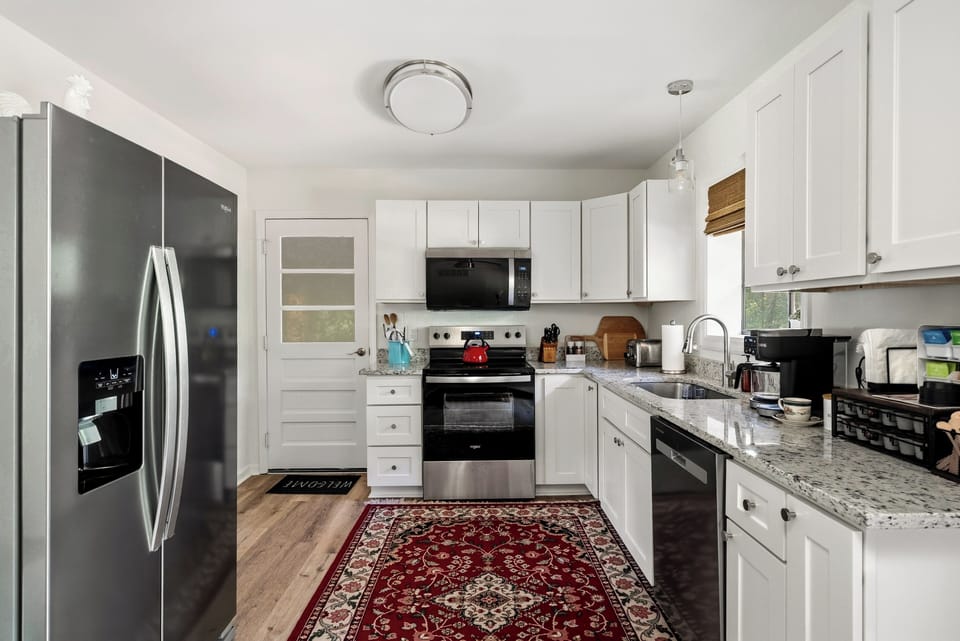 Fully stocked kitchen:  fridge, dishwasher, stove/oven, microwave, dishes, glassware, cutlery, wine glasses, coffee & tea bar, pots & pans, cookie sheet, blender, toaster, cooking utensils