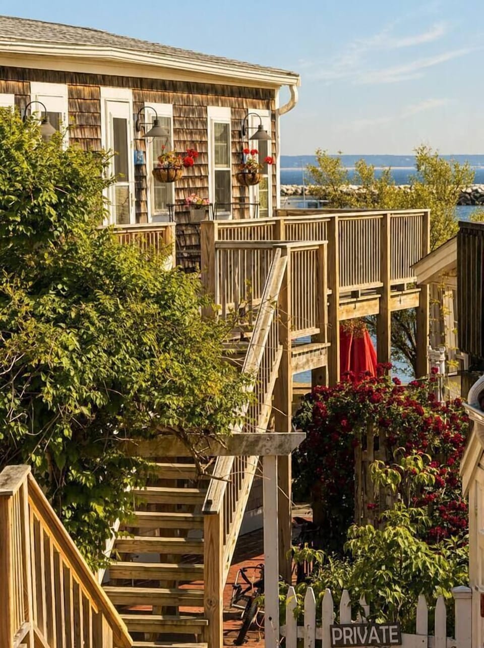 Charming coastal cottage with private entry, lush garden path, and water views nearby