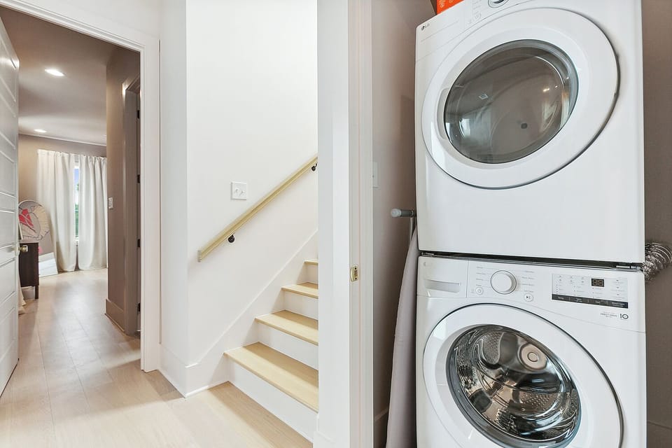 Bright hallway with in-unit washer/dryer and sleek modern finishes