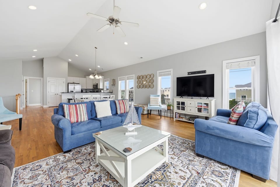 Bright coastal living room with easy access to the deck