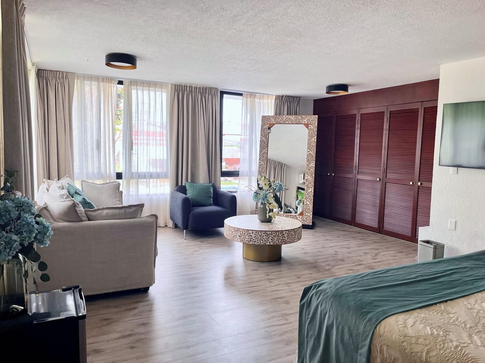 Superior Suite, Pool View | Minibar, in-room safe, laptop workspace, blackout drapes
