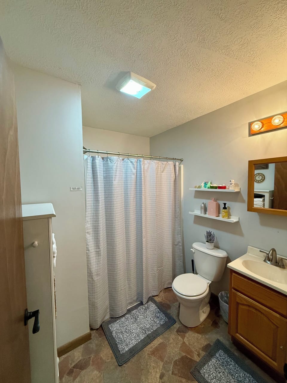 Fully stocked bathroom with walk-in shower. 