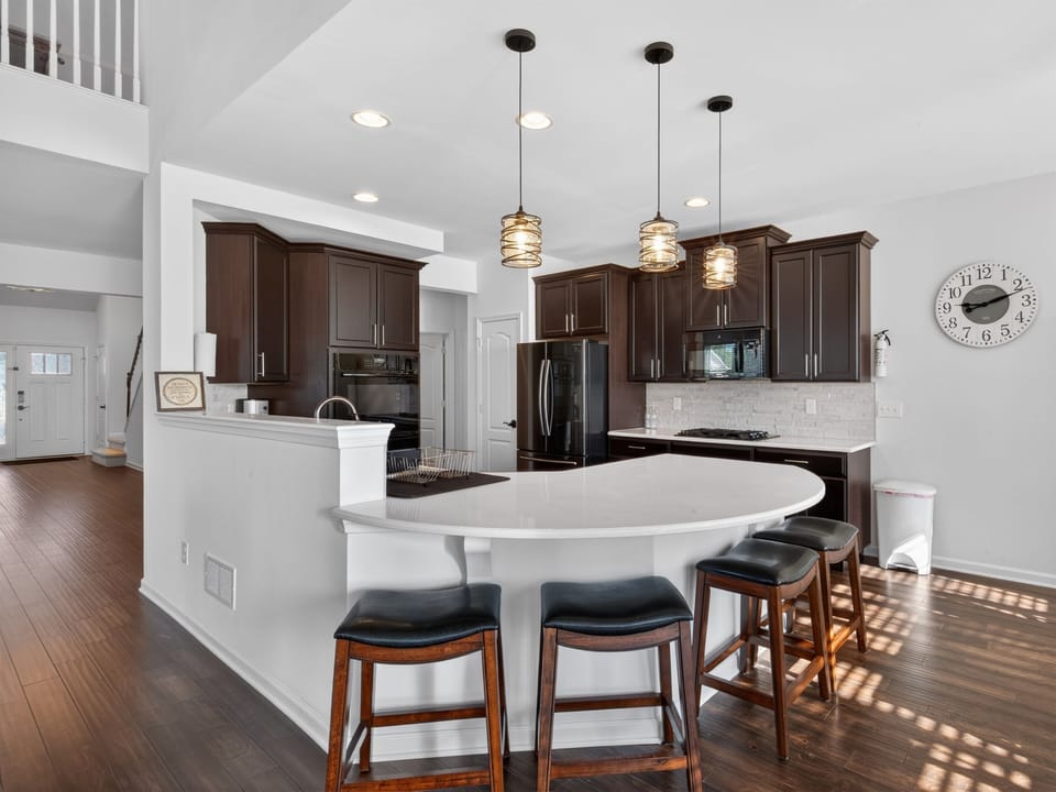 Quartz countertops, stainless steel appliances, gas cooktop, double oven, bottom freezer refrigerator, coffee maker, blender, toaster, full set of dishes, utensils, pots and pans