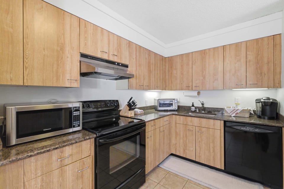 Full kitchen with light oak cabinetry floor-to-ceiling, a full appliance suite, and room for the whole group to pitch in on dinner.