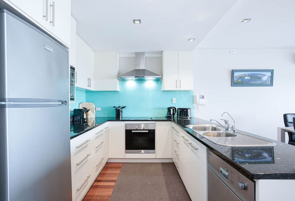 A bright, modern kitchen with generous bench space and quality appliances makes preparing meals feel effortless.