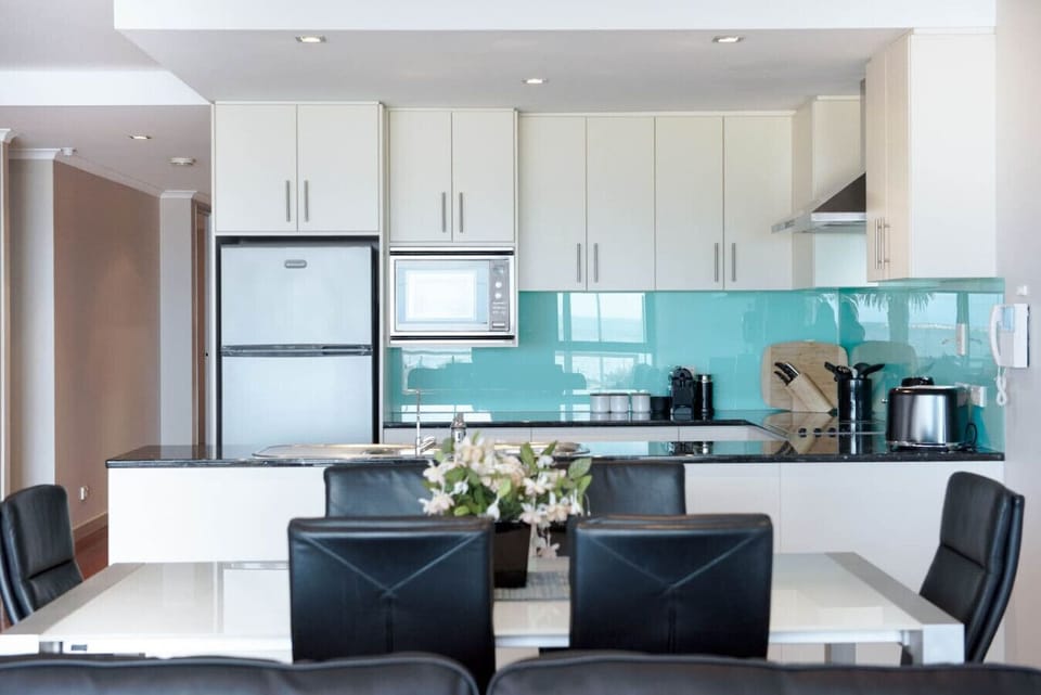 Gather around the dining table for shared meals, set within the open-plan space and framed by coastal outlooks.