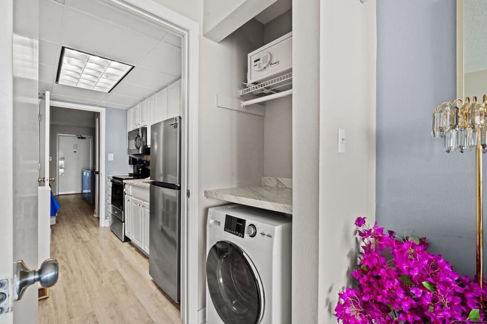 Convenient in-unit washer and dryer combo makes extended stays easy, allowing guests to refresh clothes and beachwear with ease.