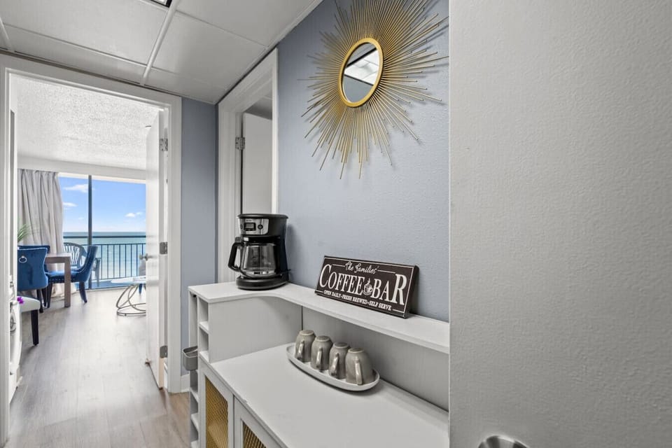 Convenient coffee bar with coffee maker and essentials, perfect for starting your mornings with fresh coffee before enjoying the beach.
