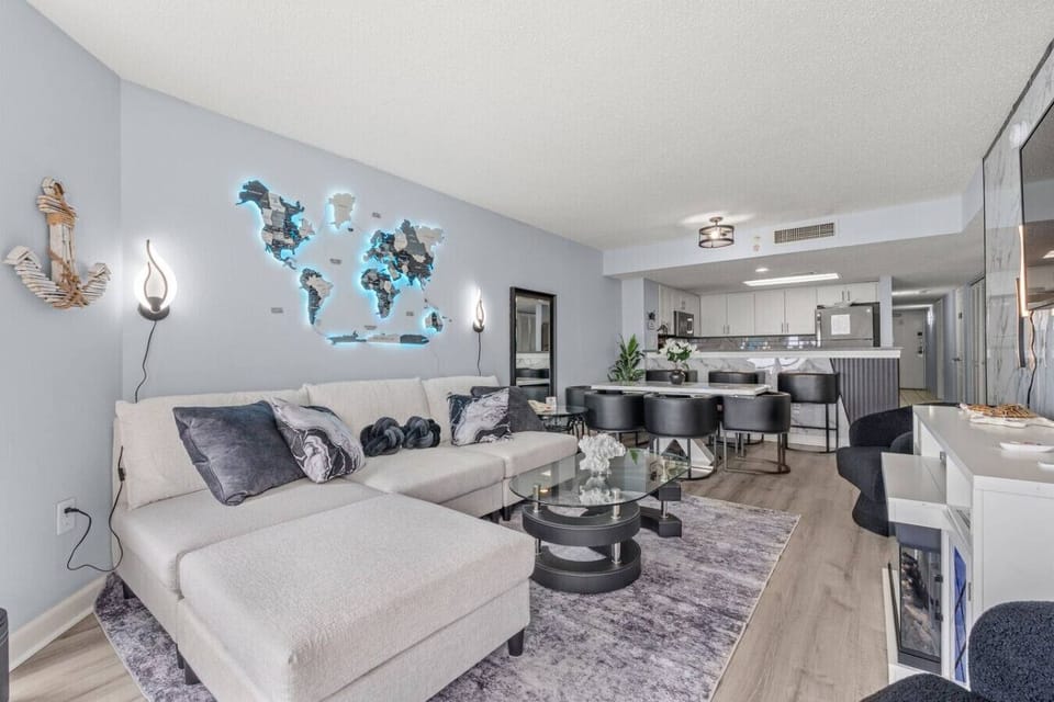 Stylish living room featuring upscale coastal decor, plush seating, Smart TV, and elegant design—perfect for relaxing in comfort after a day at the beach.