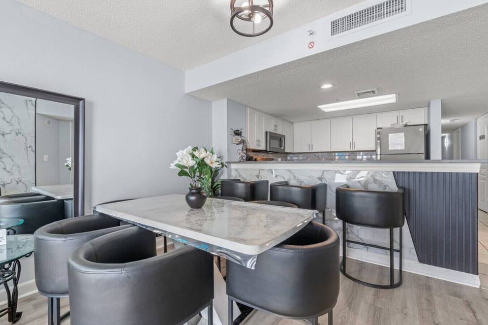 Modern stylish dining area with sleek comfortable seating, elegant coastal design, and the perfect space for family meals, morning coffee, or evening gatherings by the beach.